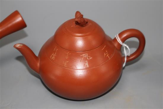 A Chinese Yixing teapot and cover, a redware teapot and cover and a cup